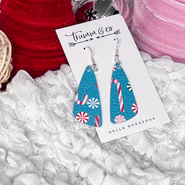 Festive angle dangle earring on fluffy white blanket