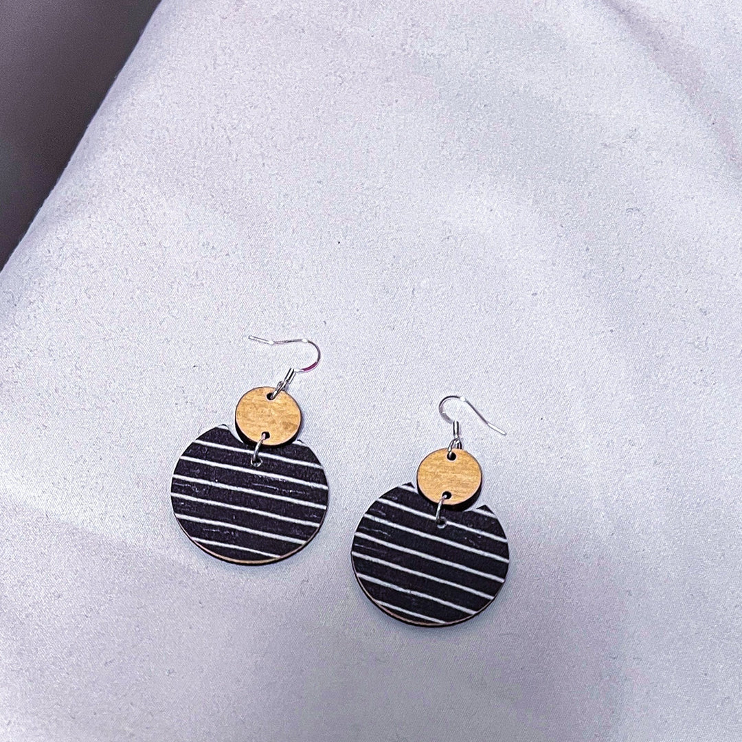 pair of semi circle earrings laying on a white cloth