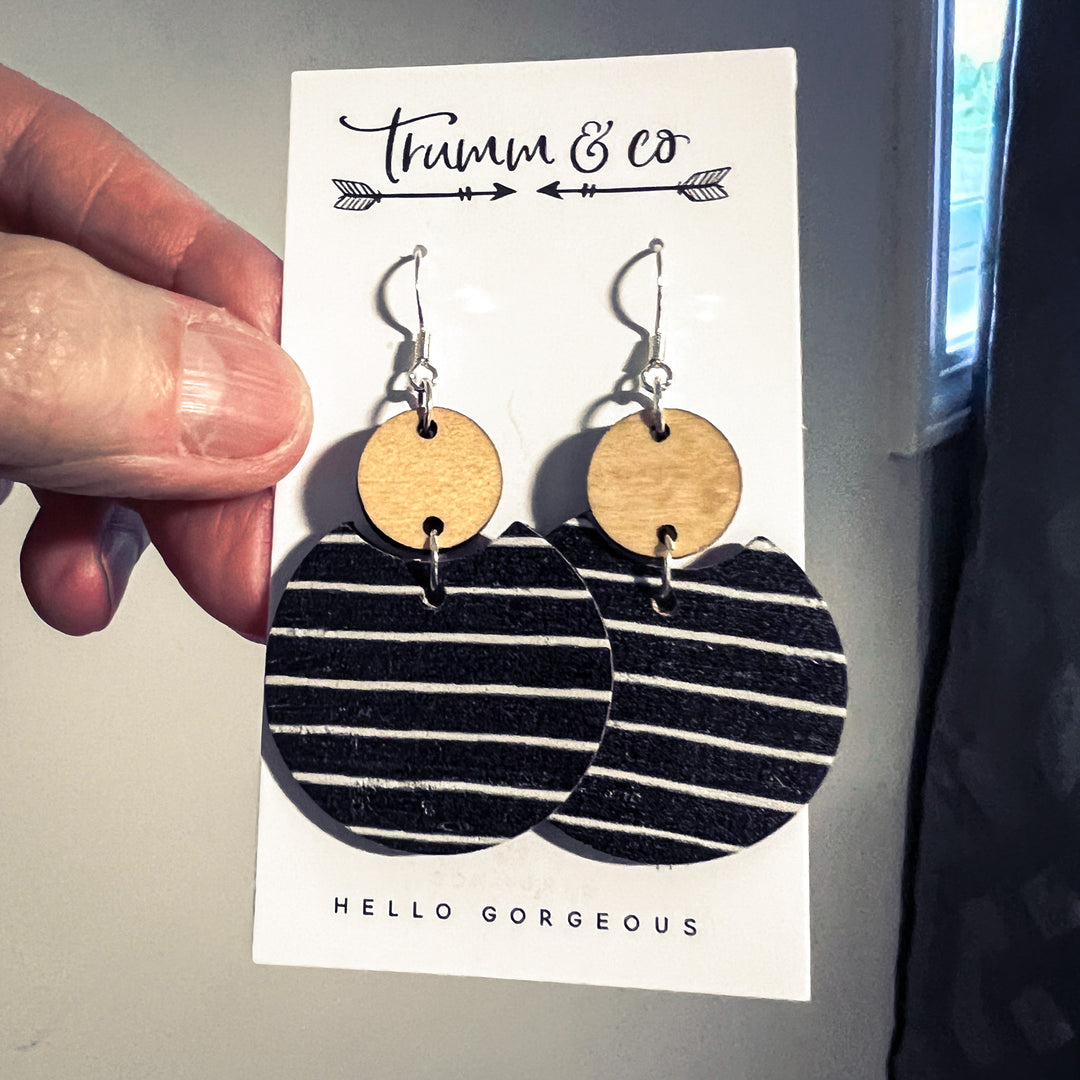pair of earrings on a card from Trumm & Co. Black/white stripe with wood connector